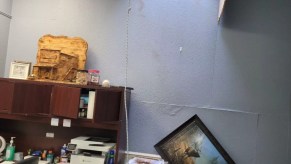 A hole cut into a car dealership office ceiling shows how far thieves are willing to go to steal cars