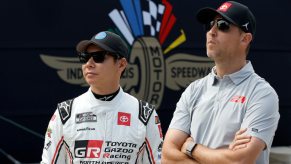 Denny Hamlin and Kamui Kobayashi stand together.