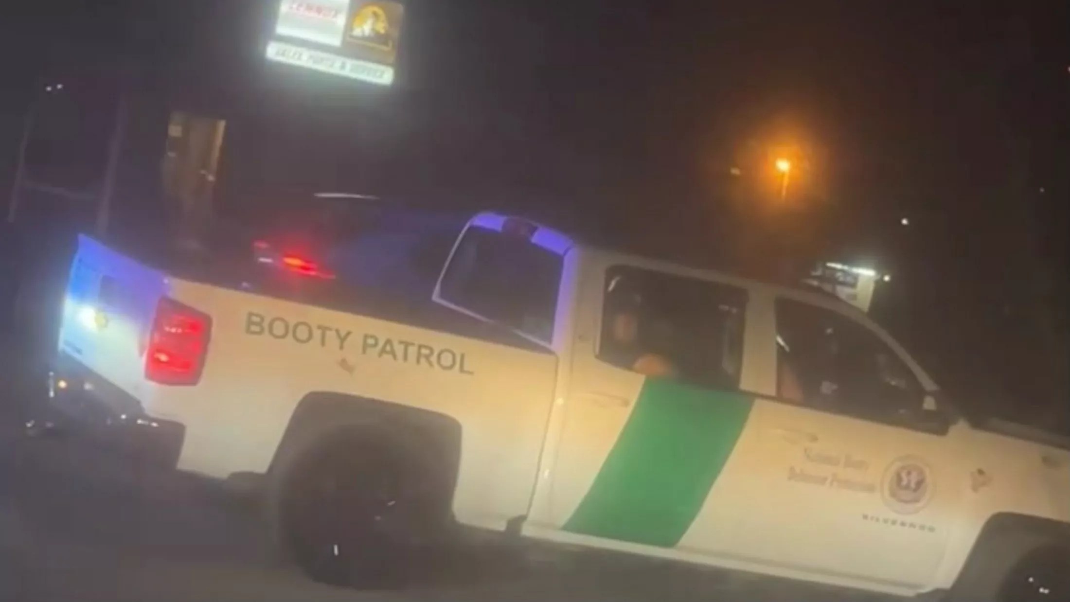 A white pickup truck with decals making it look like a Boarder Patrol agent but instead its says "Booty Patrol" on the side.