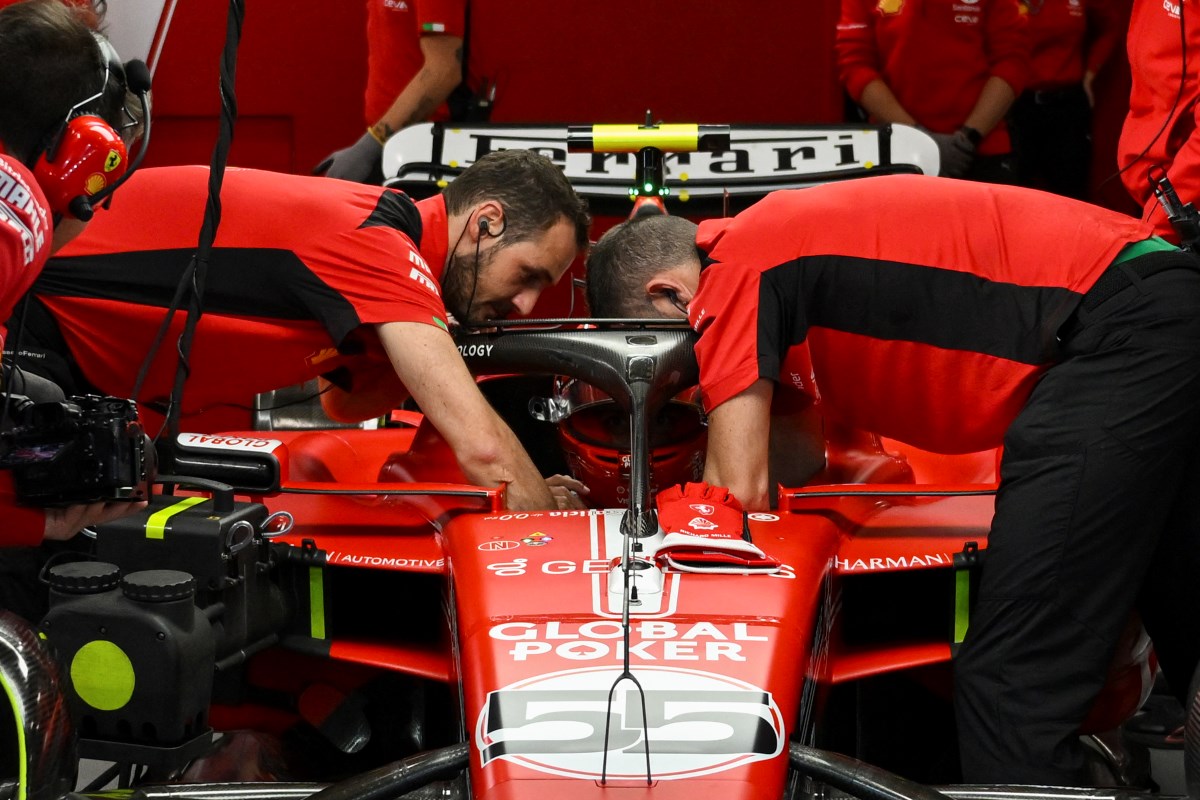 Ferrari mechanics repairing Carlos Sainz's car after hitting a manhole cover at the Las Vegas Grand Prix