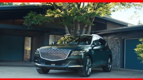 A green Genesis GV70 midsize luxury SUV is parked.