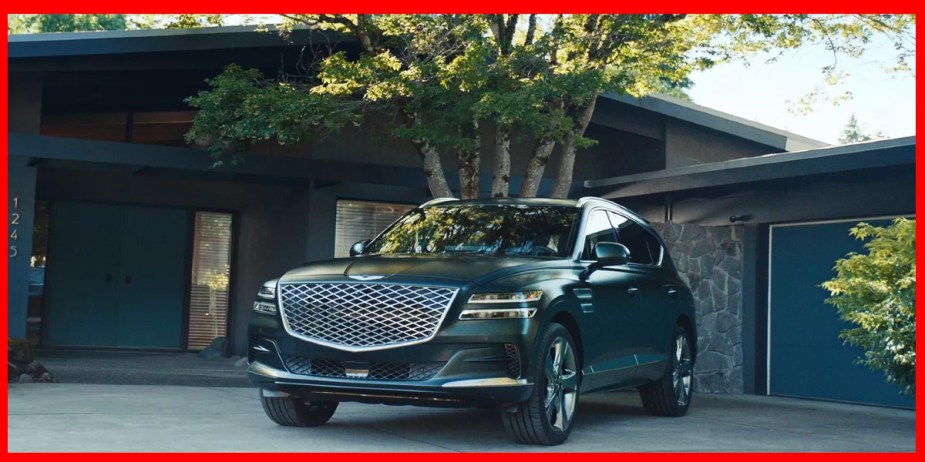 A green Genesis GV70 midsize luxury SUV is parked.