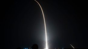 A rocket launch sends a Falcon 9 vehicle into space.