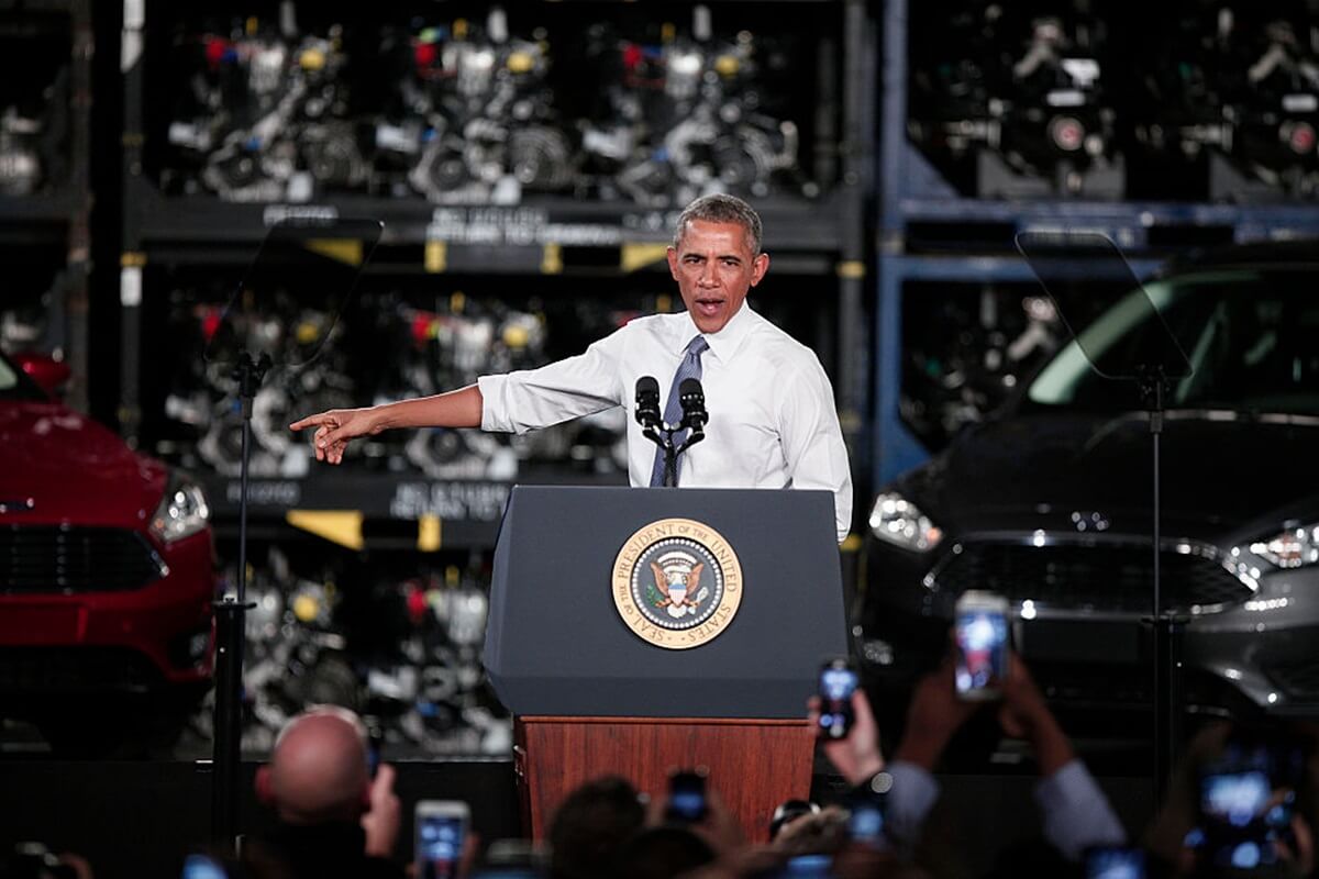 Barack Obama, a celebrity and former president, talks to car factory workers.