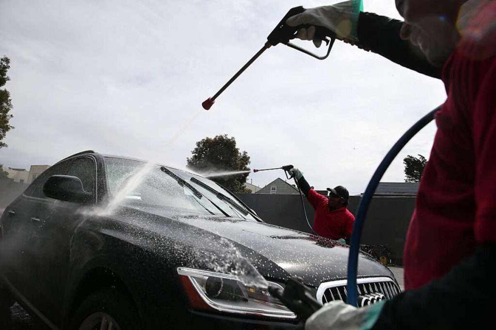 Man spraying car at car wash