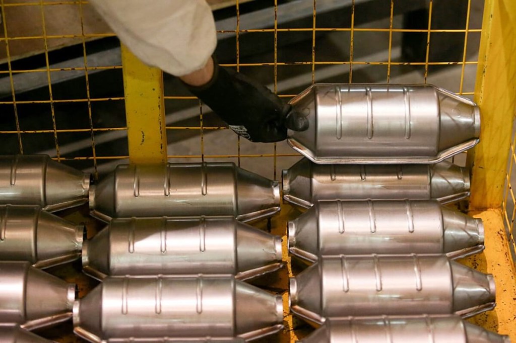 A stack of catalytic converters, one of the most stolen vehicle parts, awaits installation.