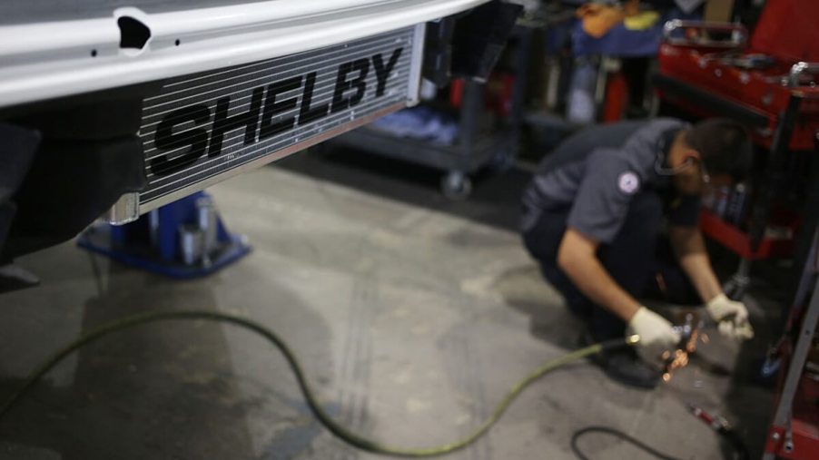 A Shelby tech works on a Ford Mustang before the company focuses on the S650.