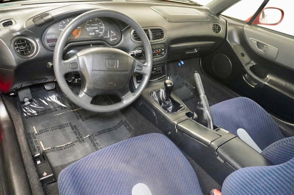 Black and blue interior of the 1995 Honda Civic Del Sol with Milano Red exterior that sold for over $8,000 on Cars and Bids