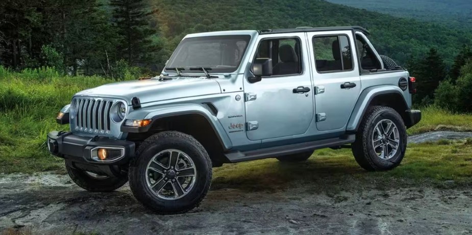 A gray Jeep Wrangler 4xe small plug-in hybrid SUV is parked. 