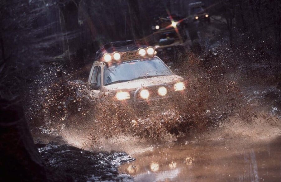 A Land Rover kicks up mud in the most important race in the marque's history, the Camel Trophy.