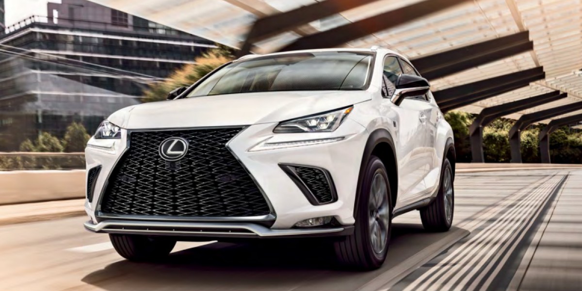 A white Lexus NX small luxury SUV is driving on the road.