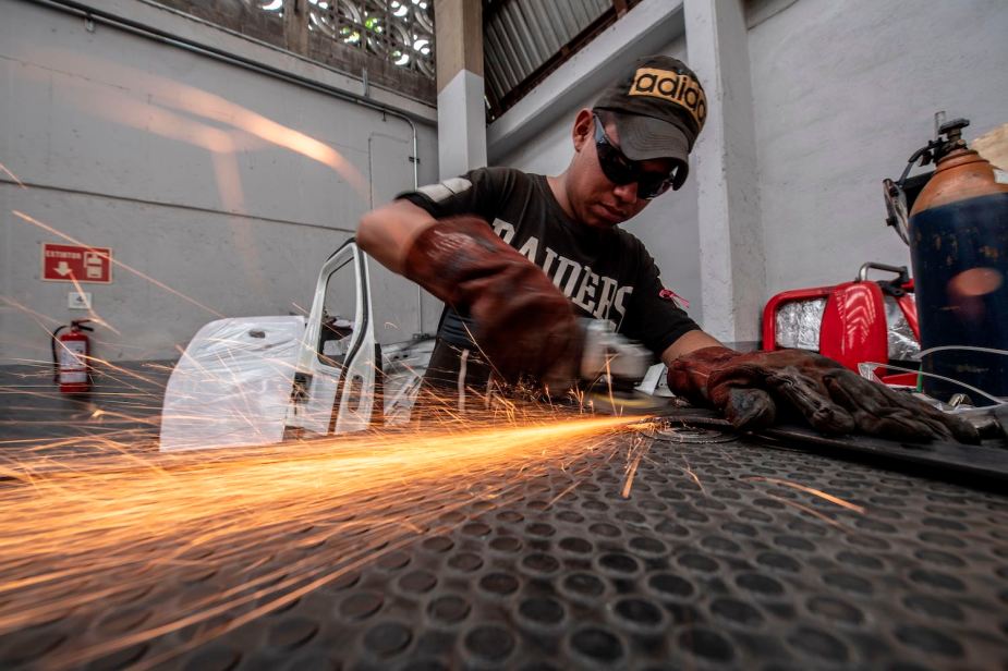 Factory worker assembled body panels for a heavy duty truck in Mexico
