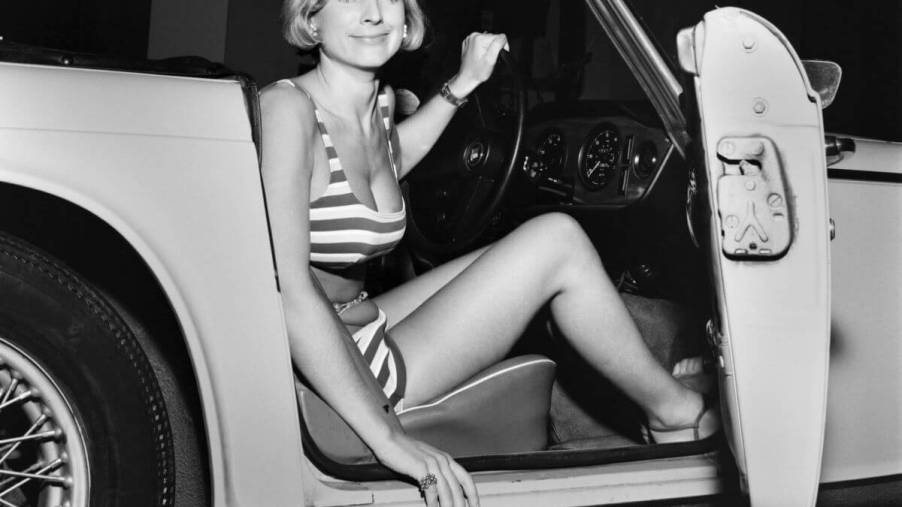 Maria Johnson, Miss Travel, seen in 1969 exiting the driver's side of a sports car in a bikini swimsuit