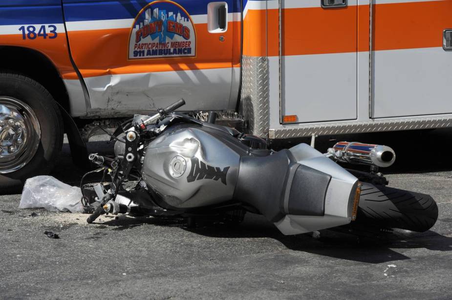 Silver motorcycle crashed into an ambulance.