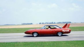 A Plymouth Superbird driving on an open road.