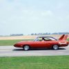 A Plymouth Superbird driving on an open road.
