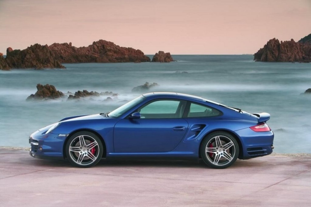 A Porsche 911 Turbo 997, like the one in Taylor Swift's car collection, sits by the beach.