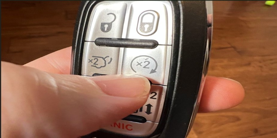 A person is activating the remote start on their vehicle.