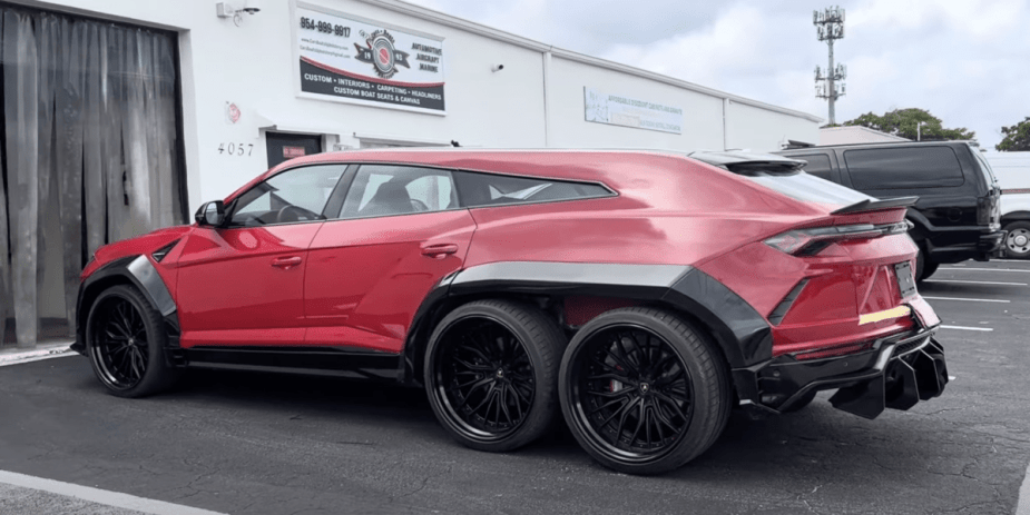 Red 6x6 Lamborghini Urus SUV with black fender extensions