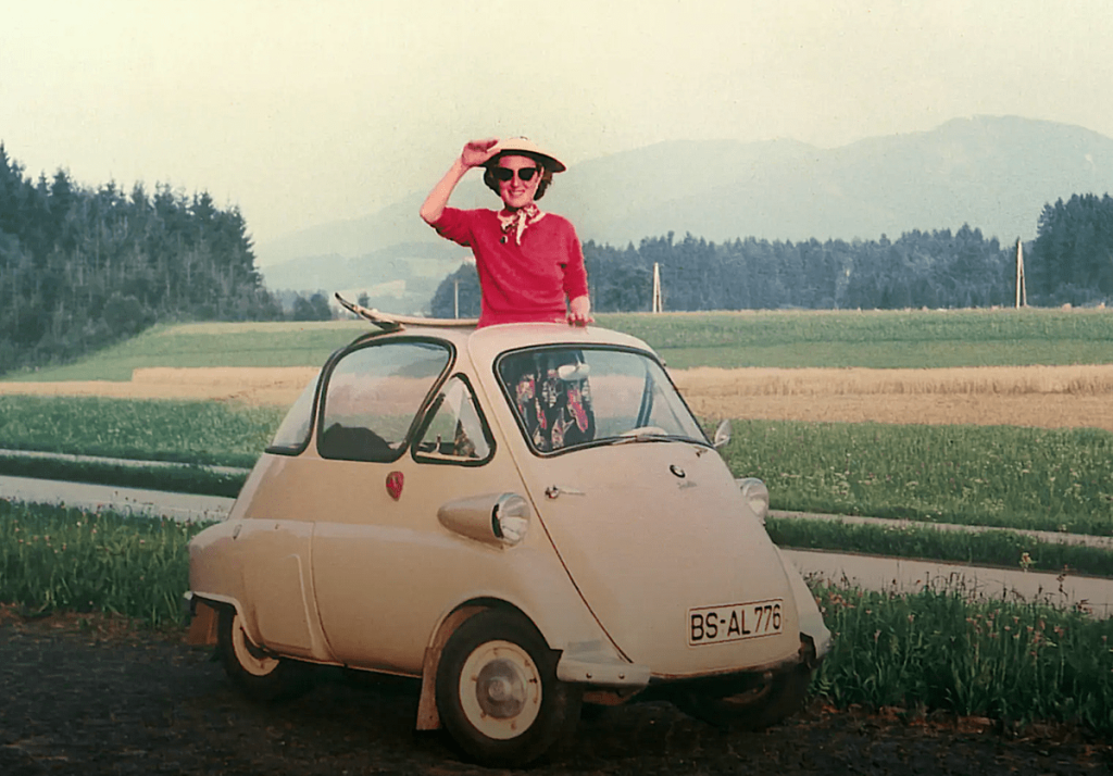 1962 BMW 700 Isetta with woman in sunroof