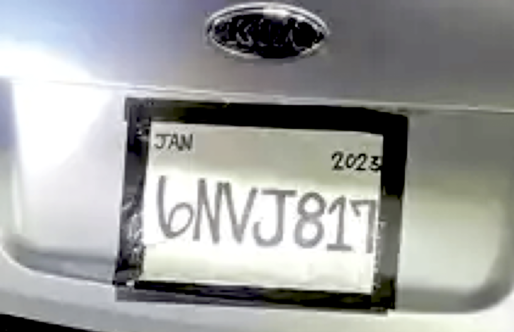 Fake license plate on Kia Rio showing black tape