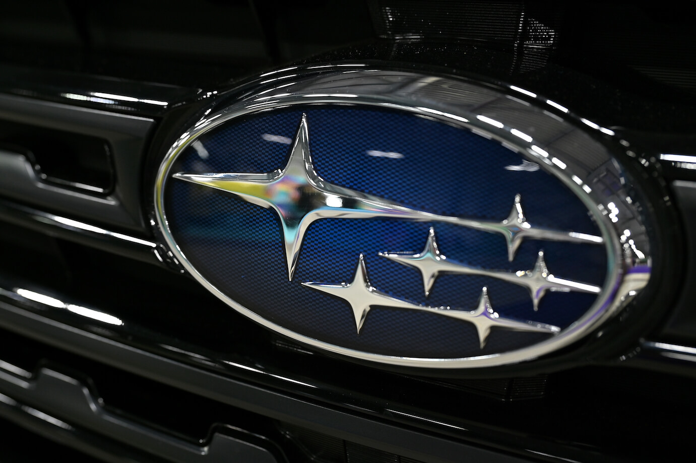 The Subaru logo on the front grille of a Subaru. Customers are very loyal to the Subaru brand.