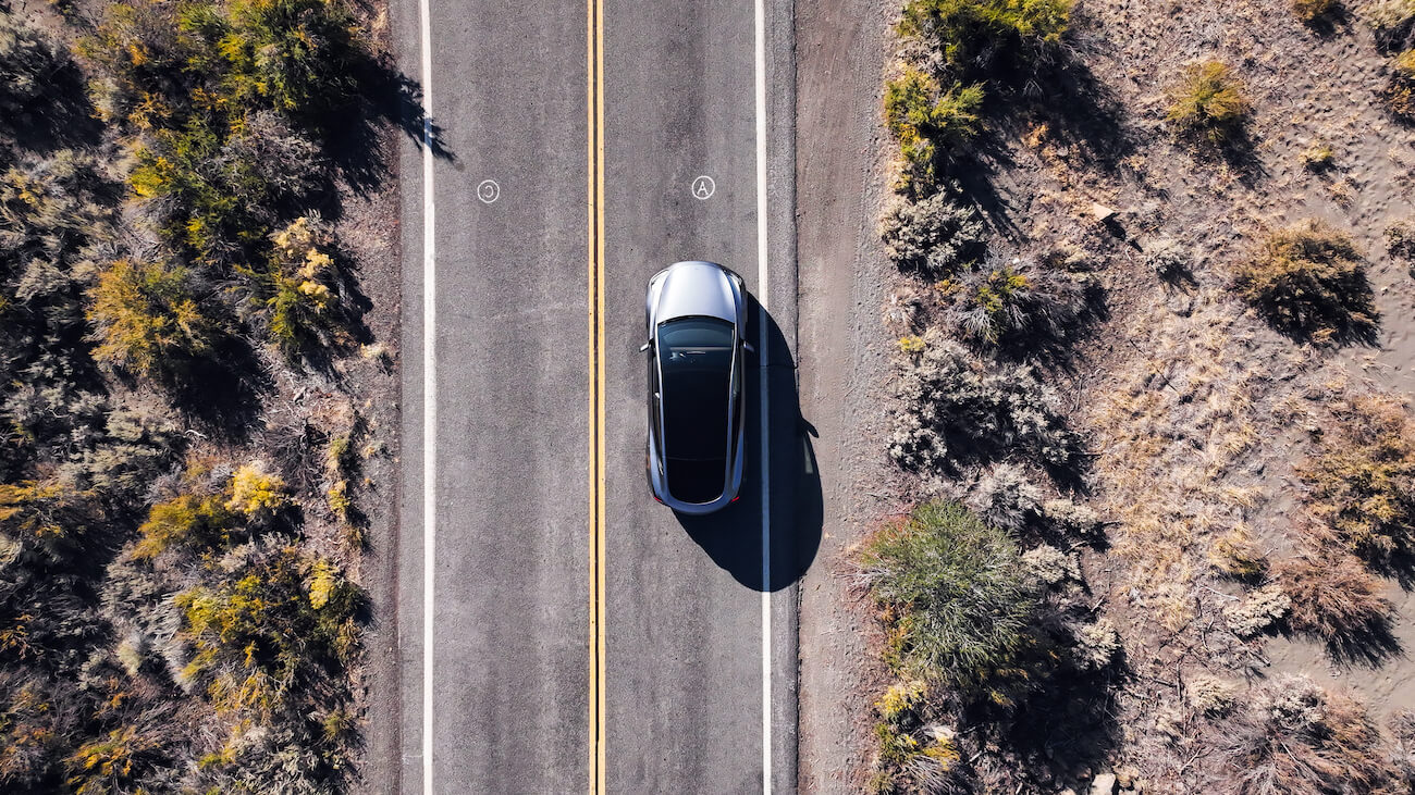An overhead view of a Tesla Model Y that makes the electric car sound when put in reverse.