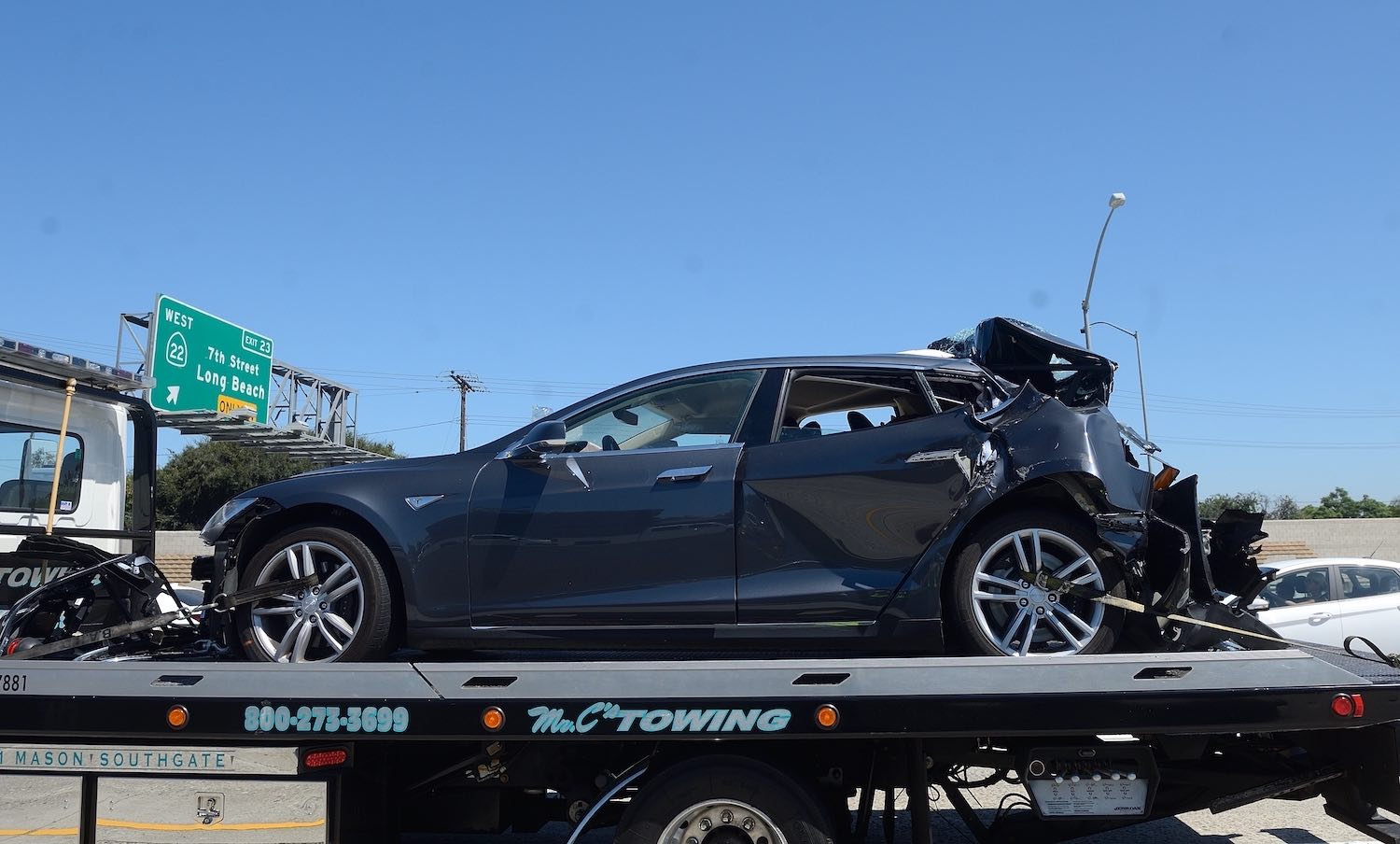 Tesla car on a tow truck after a self-driving crash.