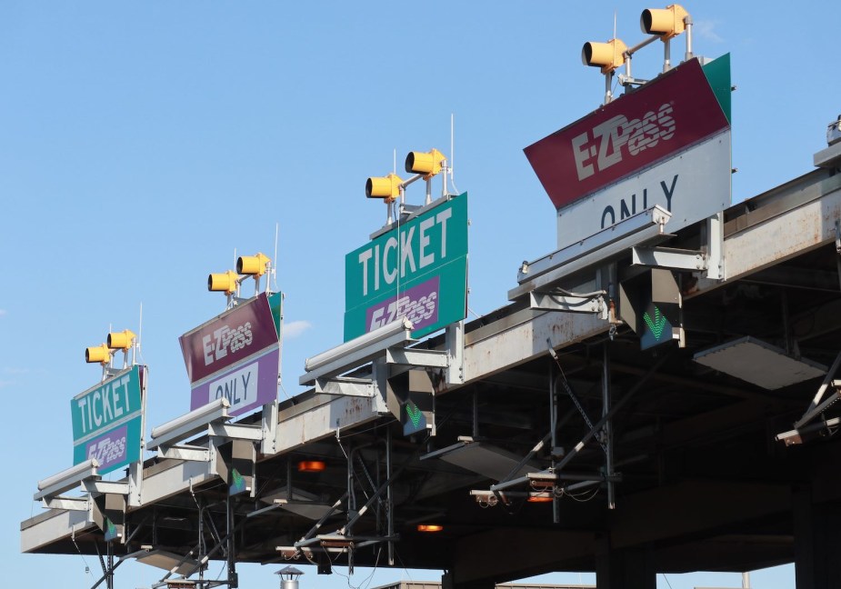 E-ZPass signs above a toll plaza on a highway.