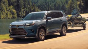 A blue 2024 Toyota Grand Highlander is driving off-road.