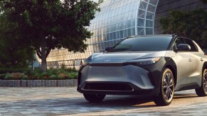 A gray 2023 Toyota bZ4X small electric SUV is driving.
