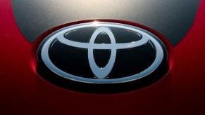 Silver Toyota logo against a black and red background.