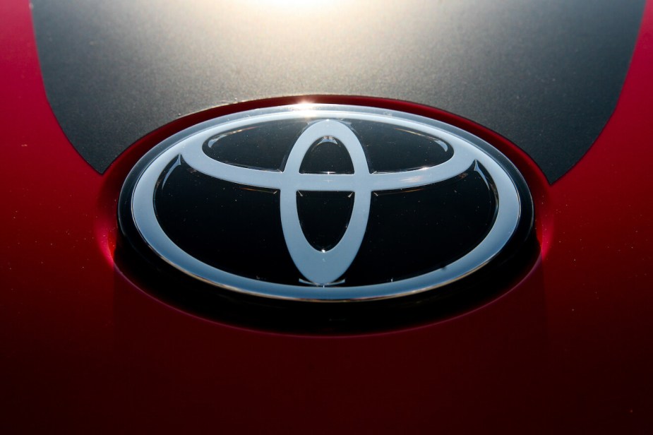 Silver Toyota logo against a black and red background.