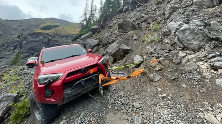 Toyota 4Runner on a Rocky Mountain trail held by come-alongs