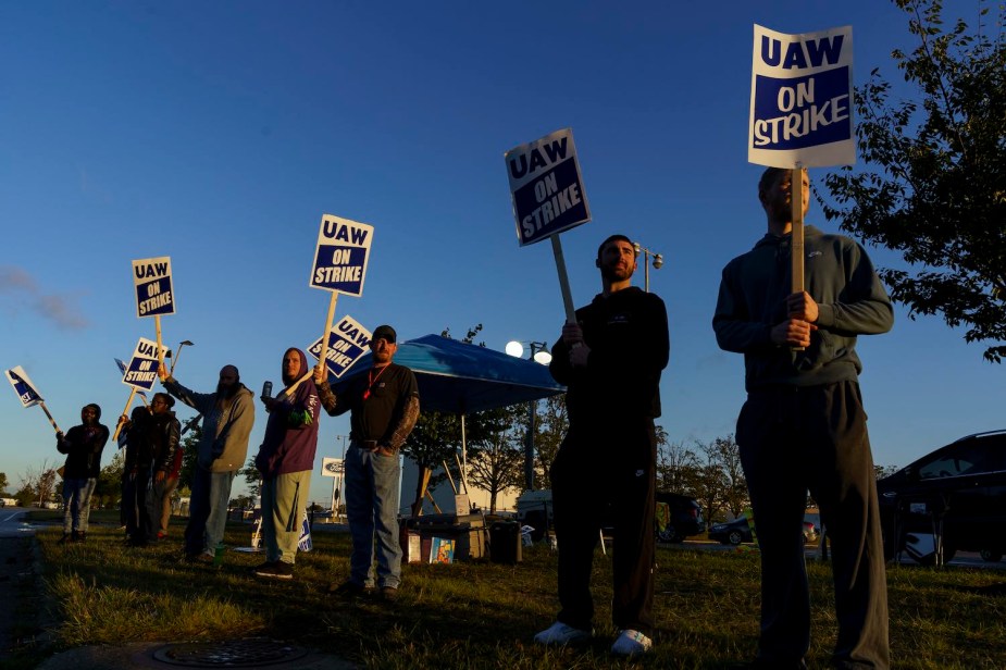 A row of UAW autoworkers strike at a Ford plant.