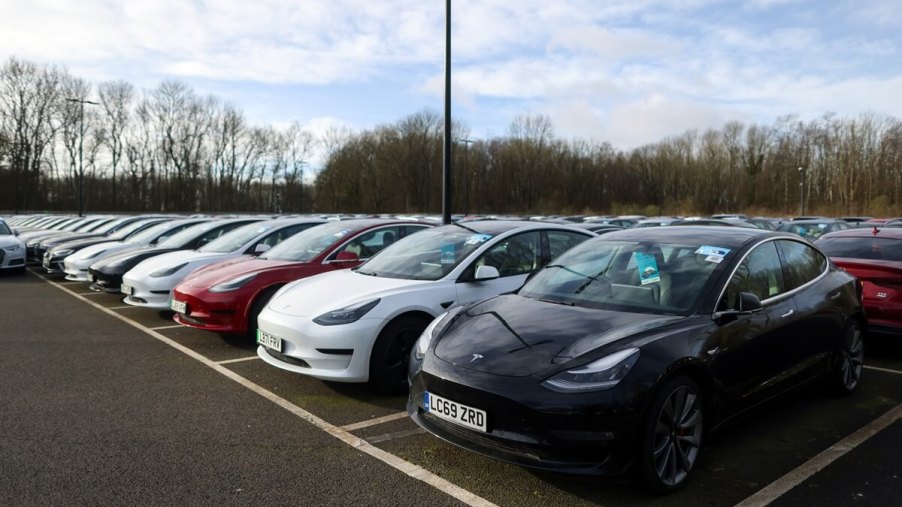 A lot full of used Tesla electric cars await sale with prices lower than last year.