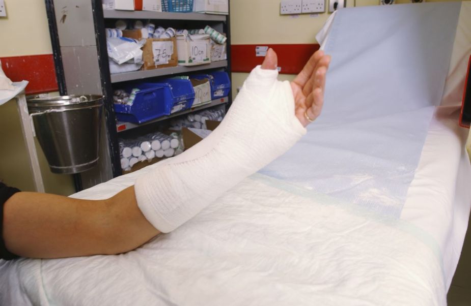A woman with a broken left arm having a cast formed on it in white plaster. Is she still allowed to drive?