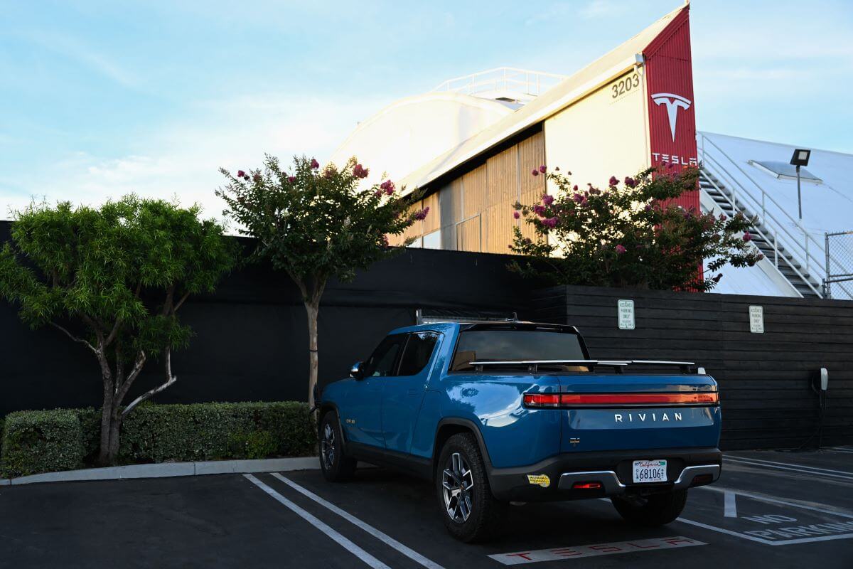 A Rivian R1T full-size electric pickup truck model parked outside a Tesla Inc. location in Hawthorne, California