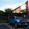 A Rivian R1T full-size electric pickup truck model parked outside a Tesla Inc. location in Hawthorne, California