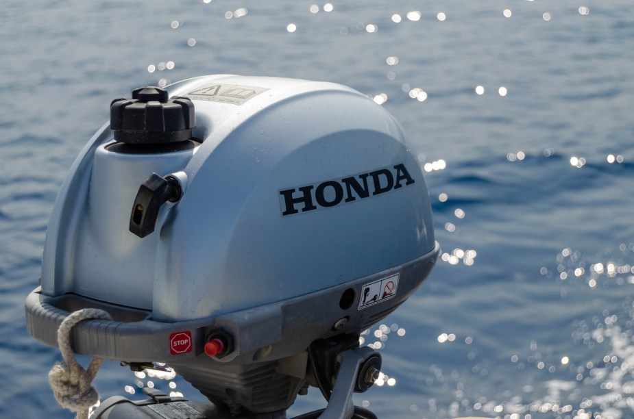A Honda boat engine is shown in close up with water in the background