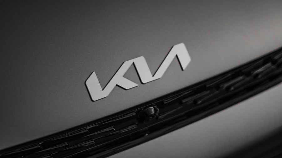 Kia emblem is shown on a black car hood