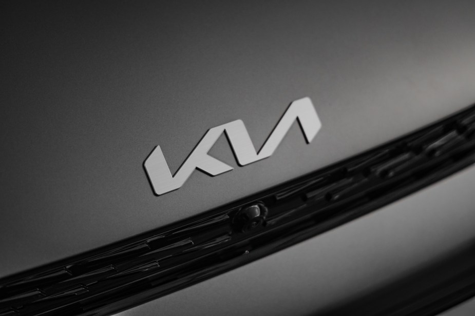 Kia emblem is shown on a black car hood