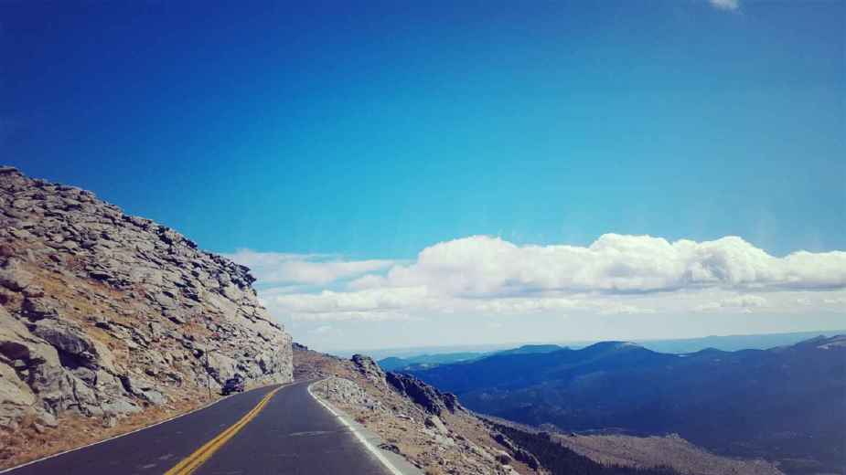 Mt. Evans in Colorado touts the highest road in the United States shown with the mountain off to the left of the road