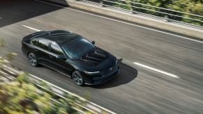 An overhead exterior shot of a 2023 Honda Accord Sport midsize sedan model as the background blurs indicating speed