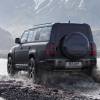 An exterior rear shot of a 2024 Land Rover Defender 130 V8 midsize off-road SUV model driving through water