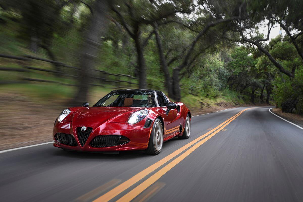 A 2020 Alfa Romeo 4C Spider 33 Stradale sports car coupe roadster model on a forest highway