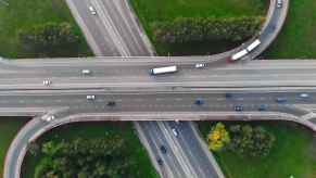Aerial view of overlapping state highways with cars and semi trucks driving