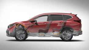 A red 2020 Honda CR-V hybrid is shown in transparent left profile view displaying its hybrid mechanics in 2023 the fuel pump was recalled