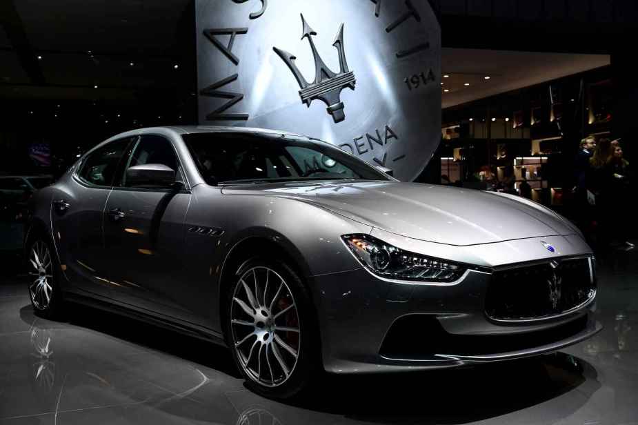 A silver 2016 Maserati Ghibli is shown parked at an auto show in right front angled view
