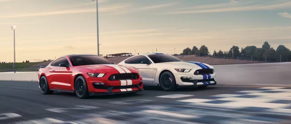 A pair of Ford Mustangs with 5.2-liter Voodoo V8 engines on a race track.